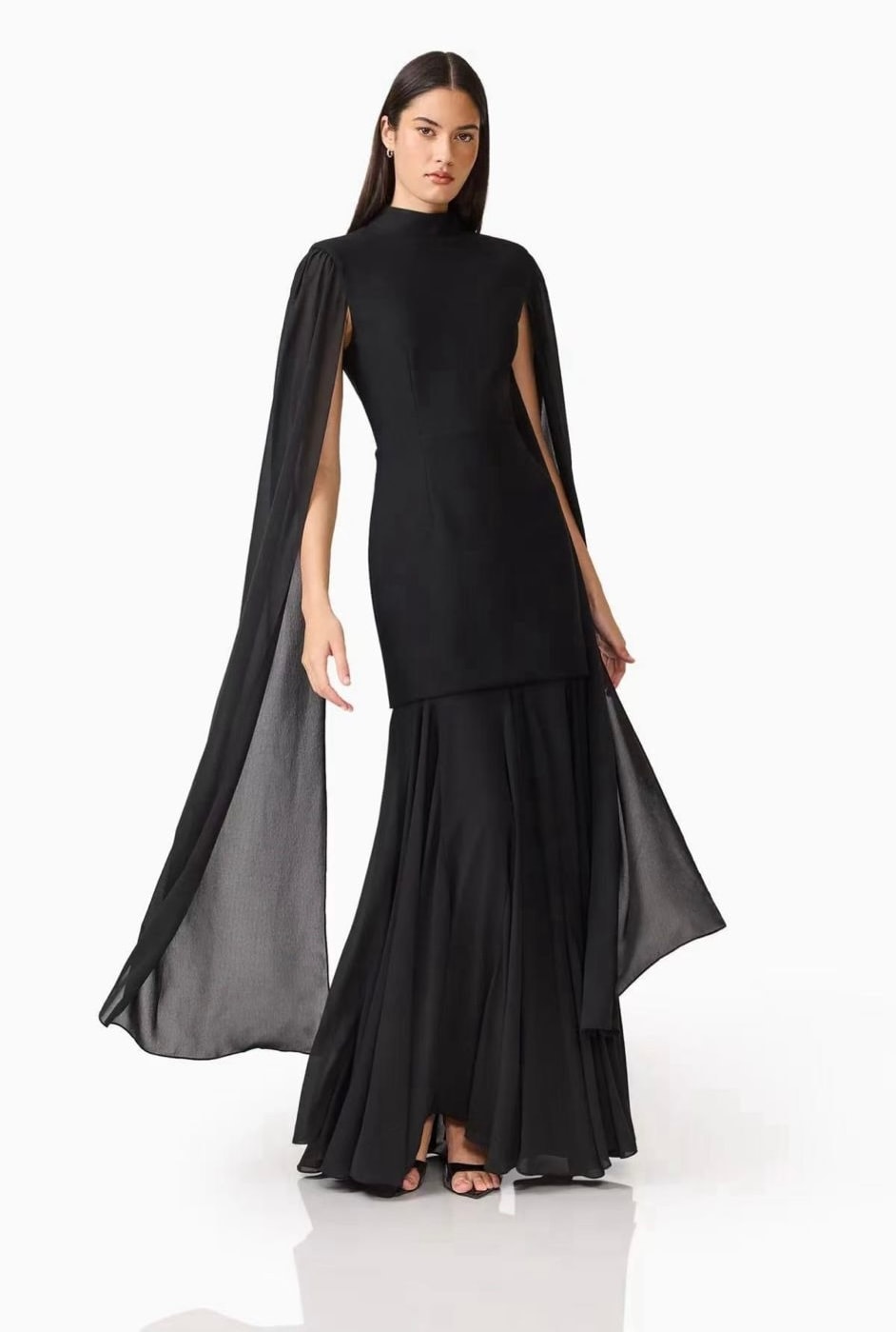 A black floor-length dress with flowing sheer cape sleeves